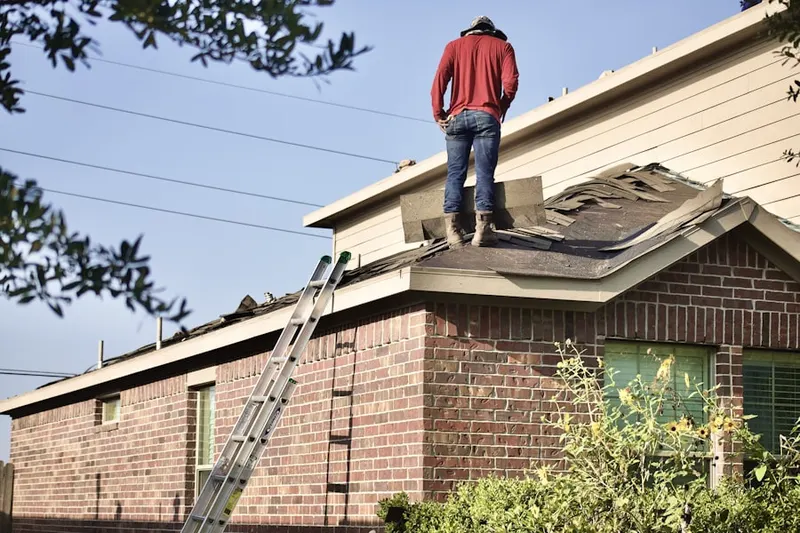 Professional roofer working on a residential roof in City Island
